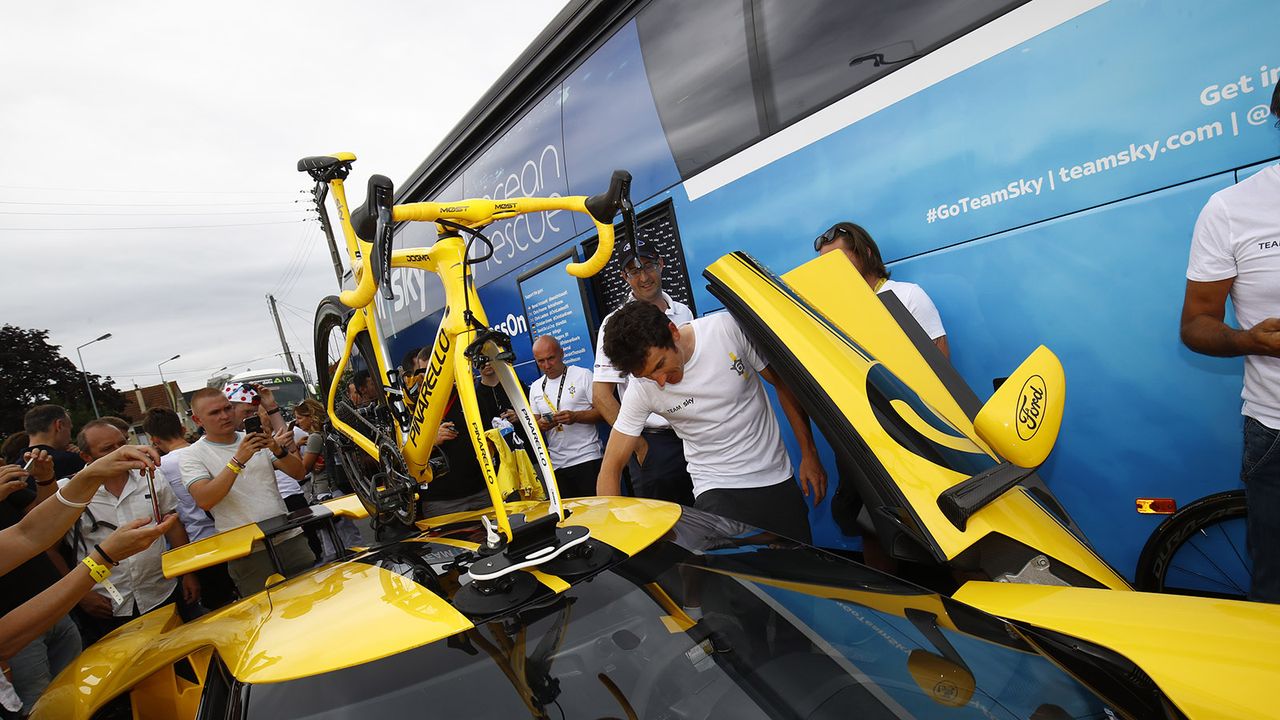 Thomas' bike was atop a matching yellow sports car ahead of the stage