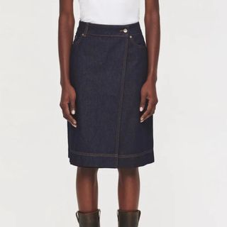 Flat lay image of a woman in a denim midi skirt