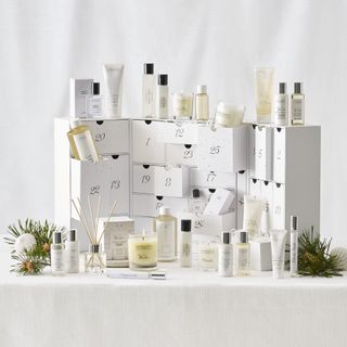 The White Company advent calendar with candles and bottles on a white background