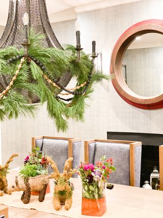 Dining table with pendant light draped with foliage and table decorations