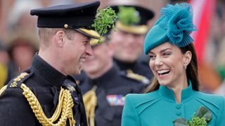Prince William, Prince of Wales and Catherine, Princess of Wales laughing during the St. Patrick's Day Parade at Mons Barracks