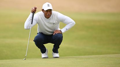 Tiger Woods lines up a putt at the 2022 Open at St Andrews