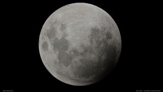 The moon's edge begins to slip into the inner (umbral) shadow of the Earth during a total lunar eclipse.