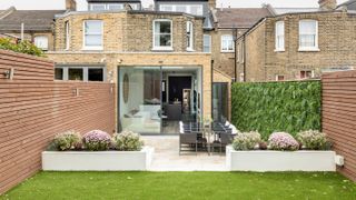 victorian terrace with modern extension and living wall in garden
