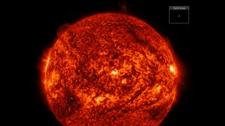 a close up view of the sun with a filament erupting off the top right section.