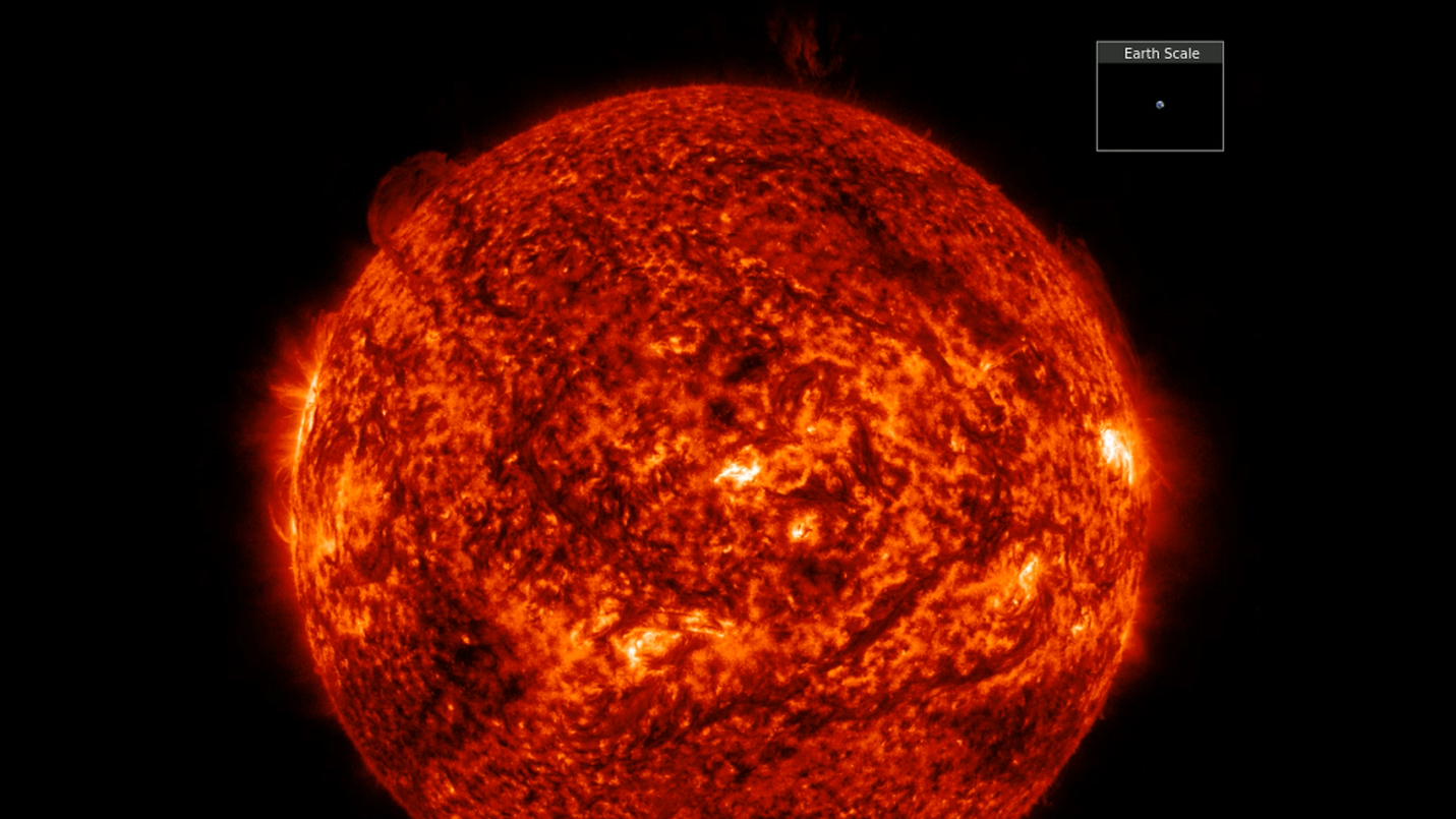 a close up view of the sun with a filament erupting off the top right section.