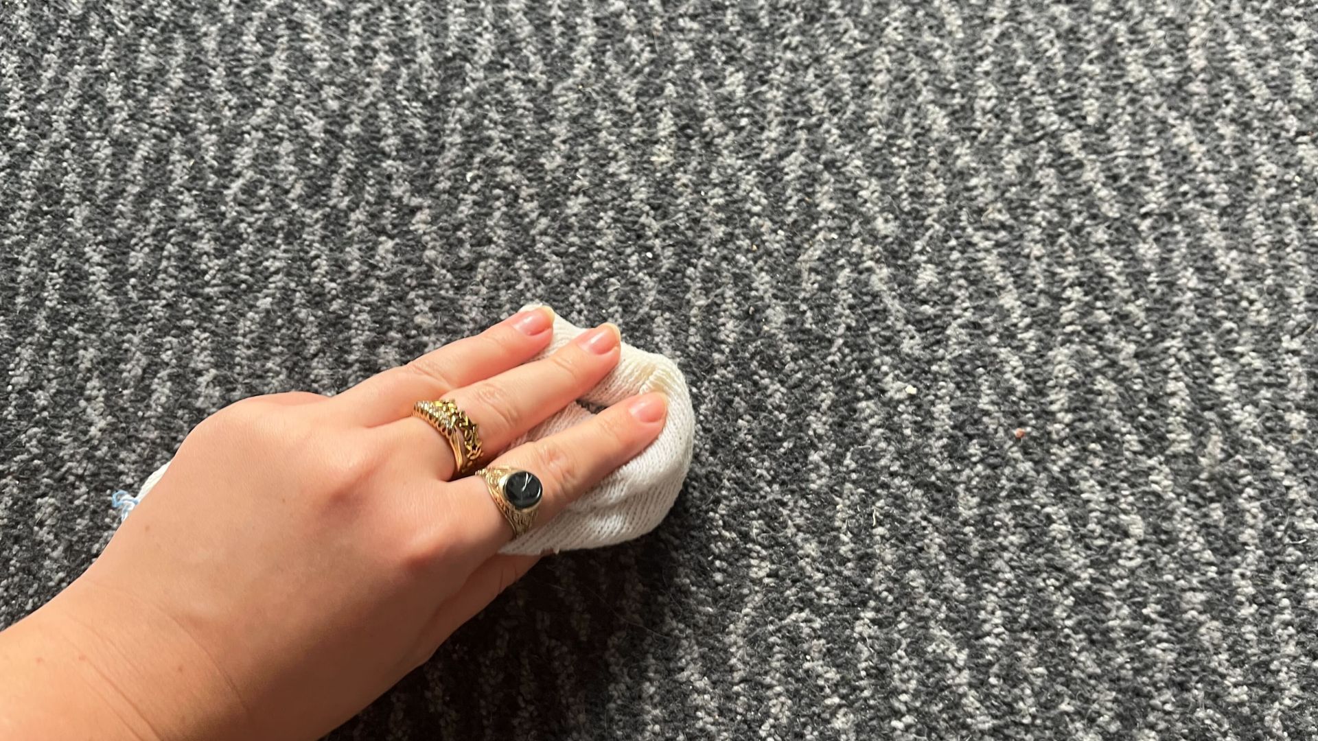 picture of hand with cloth spot cleaning a carpet