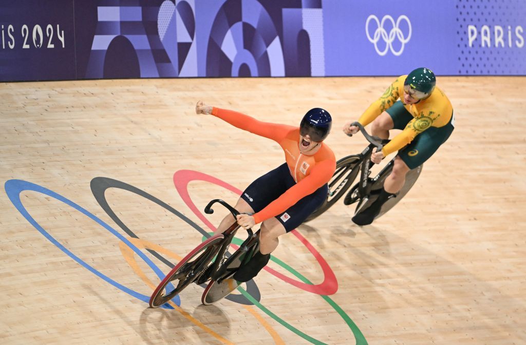 Netherlands' Harrie Lavreysen (L) celebrates winning ahead of Australia's Matthew Richardson in the men's track cycling keirin final for gold of the Paris 2024 Olympic Games at the Saint-Quentin-en-Yvelines National Velodrome in Montigny-le-Bretonneux, south-west of Paris, on August 11, 2024. (Photo by SEBASTIEN BOZON / AFP)