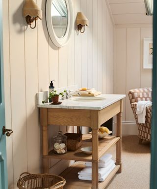 country style bathroom with panelled walls and a blue door with carpeted floor