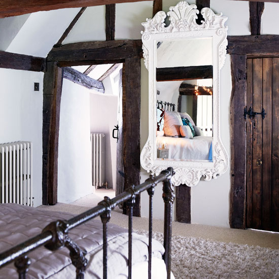 bedroom with white wall and mirror