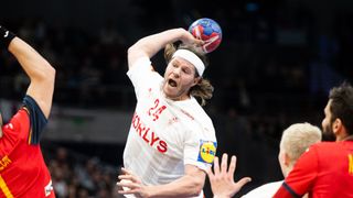 Mikkel Hansen of Denmark, in white shirt, throwing the ball ahead of the Germany vs Denmark semi-final at the Euro 2024 Handball