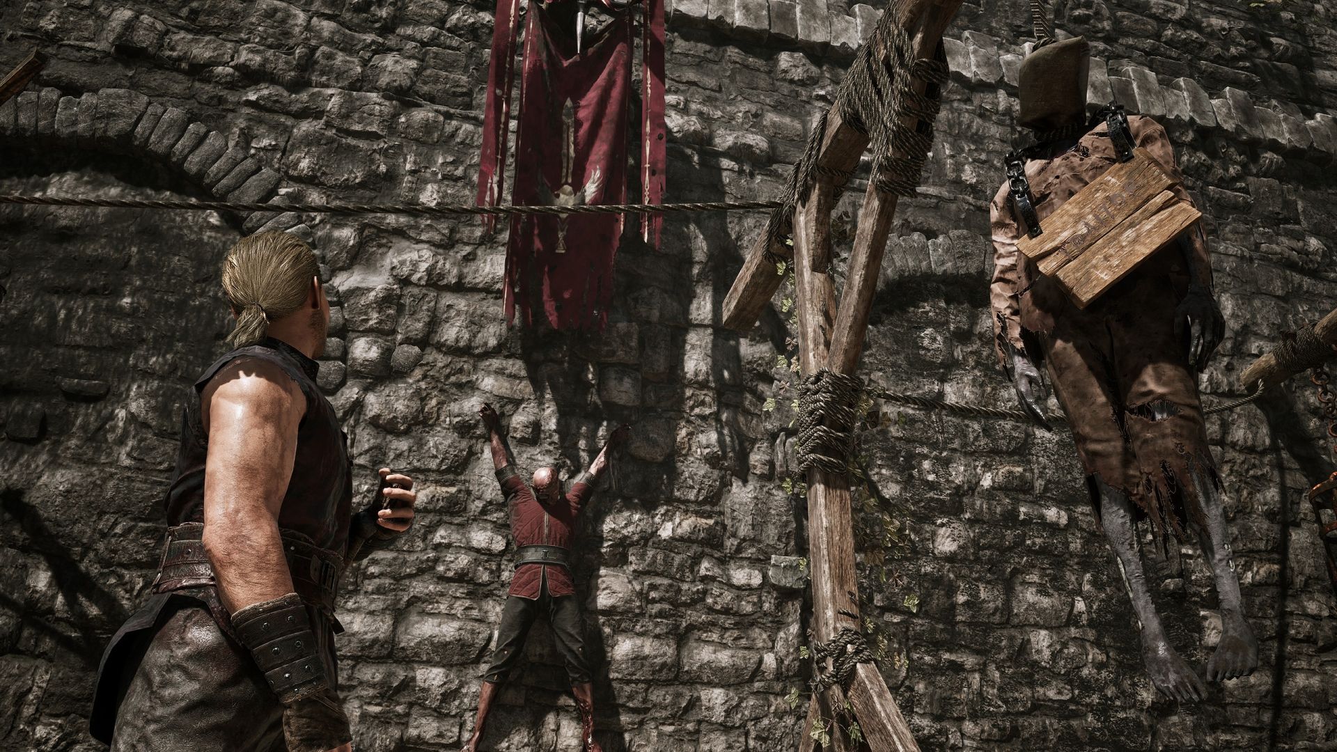 A pair of executed traitors hang by a wall in the Old Camp