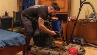 23 February: Anton Lytvyn, 28, packs his military equipment at his house in Kyiv after President Volodymyr Zelensky called the country’s army reservists in specialist fields to active duty, and declared a state of emergency