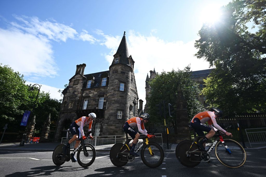 Riders from Netherlands pass the University of Glasgow as they take part in the Team Time Trial Mixed Relay road race during the UCI Cycling World Championships in Glasgow Scotland on August 8 2023 Photo by Oli SCARFF AFP Photo by OLI SCARFFAFP via Getty Images