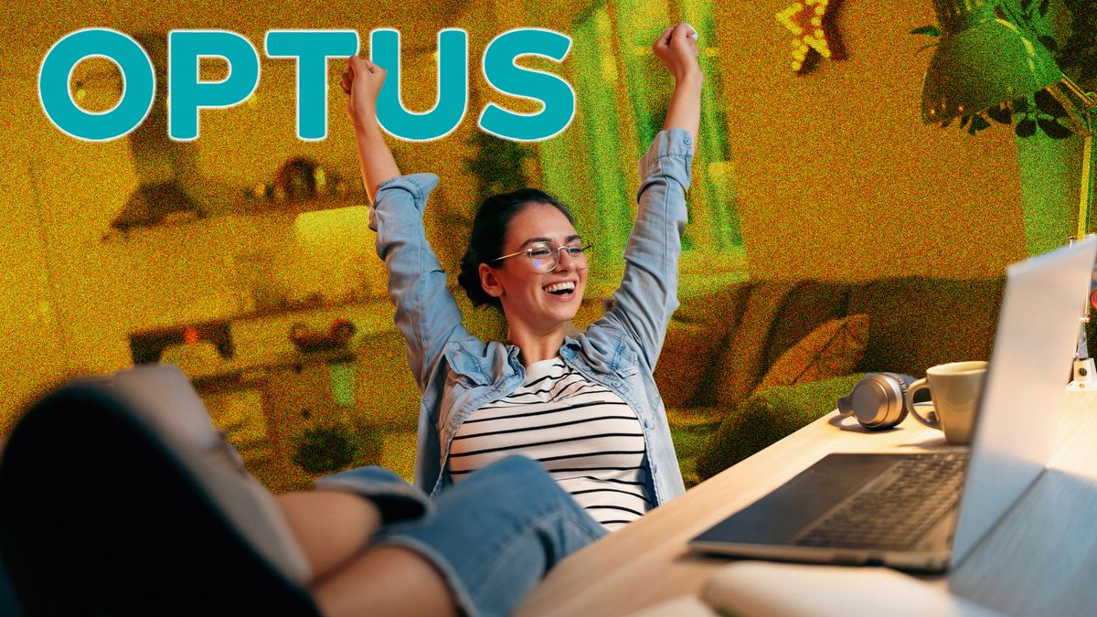 Woman wearing glasses sitting at computer with her feet on the desk. She&#039;s smiling and throwing her arms in the arm. The Optus logo is in the top left of the image.