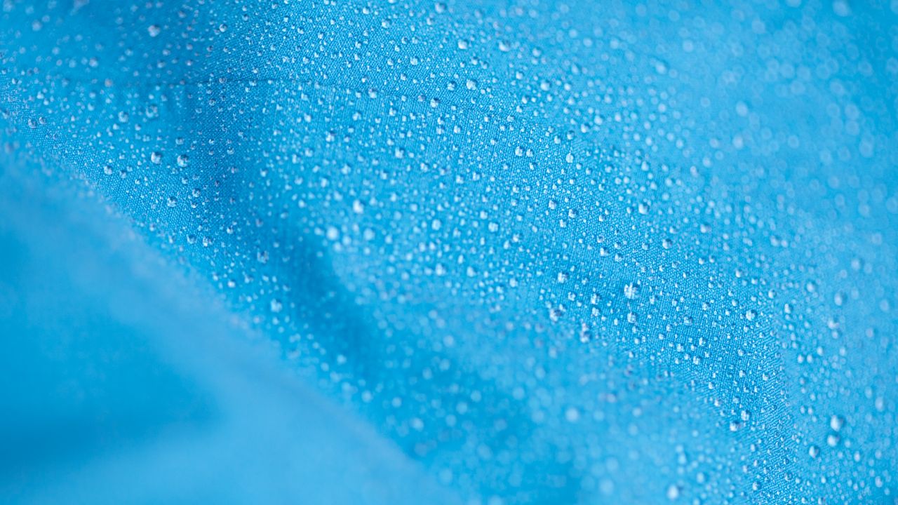 hardshell jacket up close with water on the surface