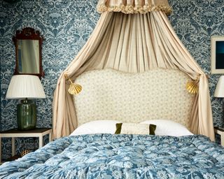 grand bedroom with canopy and blue and white fabric walling by ensemblier