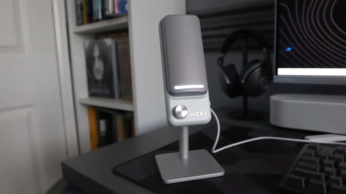 An NZXT Capsule Elite microphone set up on a desk with lighting enabled.