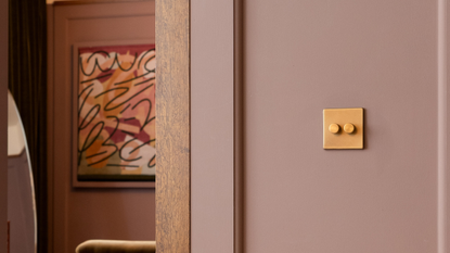 Kinetic lighting switch by Soho Lighting Co. in a lilac room