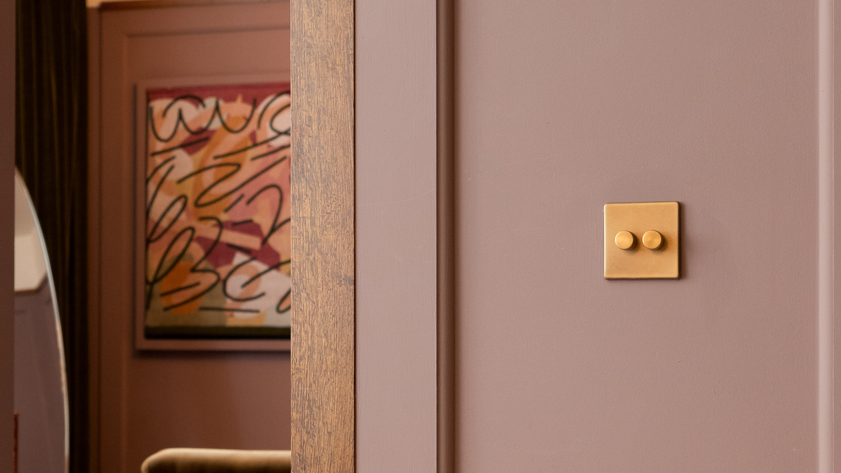 Kinetic lighting switch by Soho Lighting Co. in a lilac room