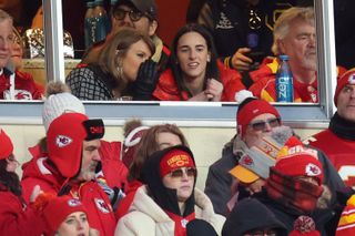 Taylor Swift whispering to Caitlin Clark at the Chiefs game