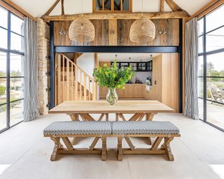 farmhouse kitchen with wood bench and beams