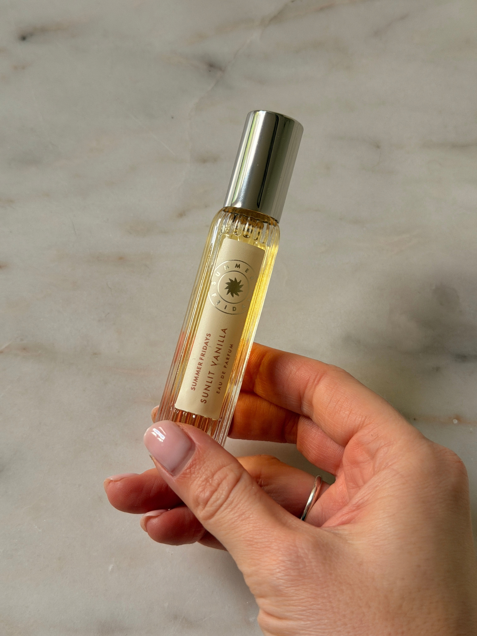 Freelance beauty editor Grace Day holding a bottle of Summer Fridays Sunlit Vanilla Eau De Parfum