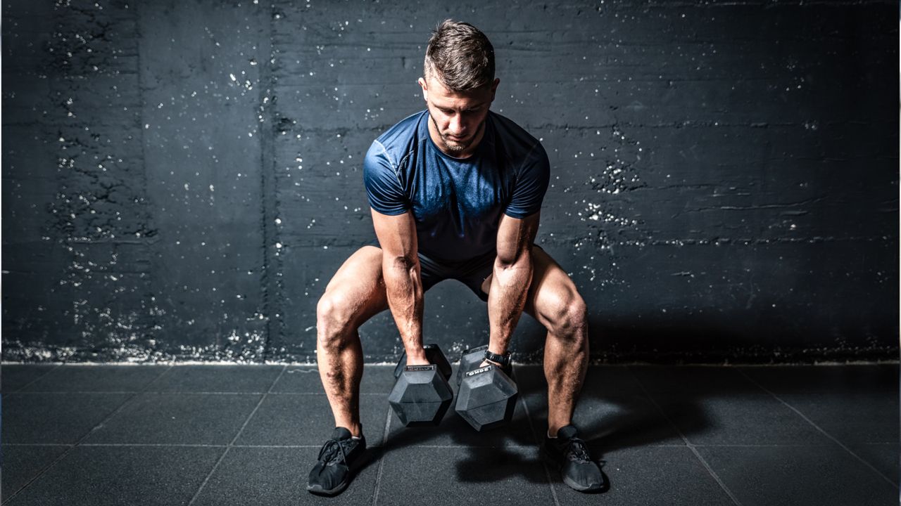 Man doing dumbbell sumo squat