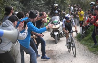 SIENA ITALY MARCH 08 Tom Pidcock of The United Kingdom and Q365 Pro Cycling Team competes in the chase group while fans cheer during the 19th Strade Bianche 2025 Mens Elite a 213km one day race from Siena to Siena 320m UCIWT on March 08 2025 in Siena Italy Photo by Tim de WaeleGetty Images