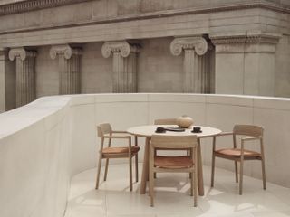 Circular wooden table with four chair and leather seating
