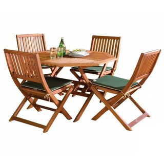 Hardwood outside table and chairs with green cushions with a salad, 2 white plates and 2 drinks on the table
