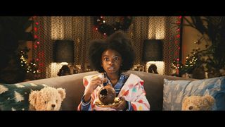 Girl holding chocolate bauble in Tesco christmas advert