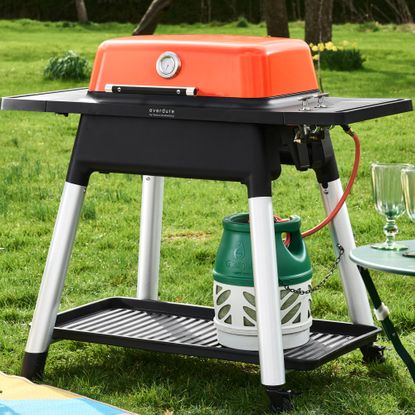 Orange Everdure Force BBQ on grass in garden