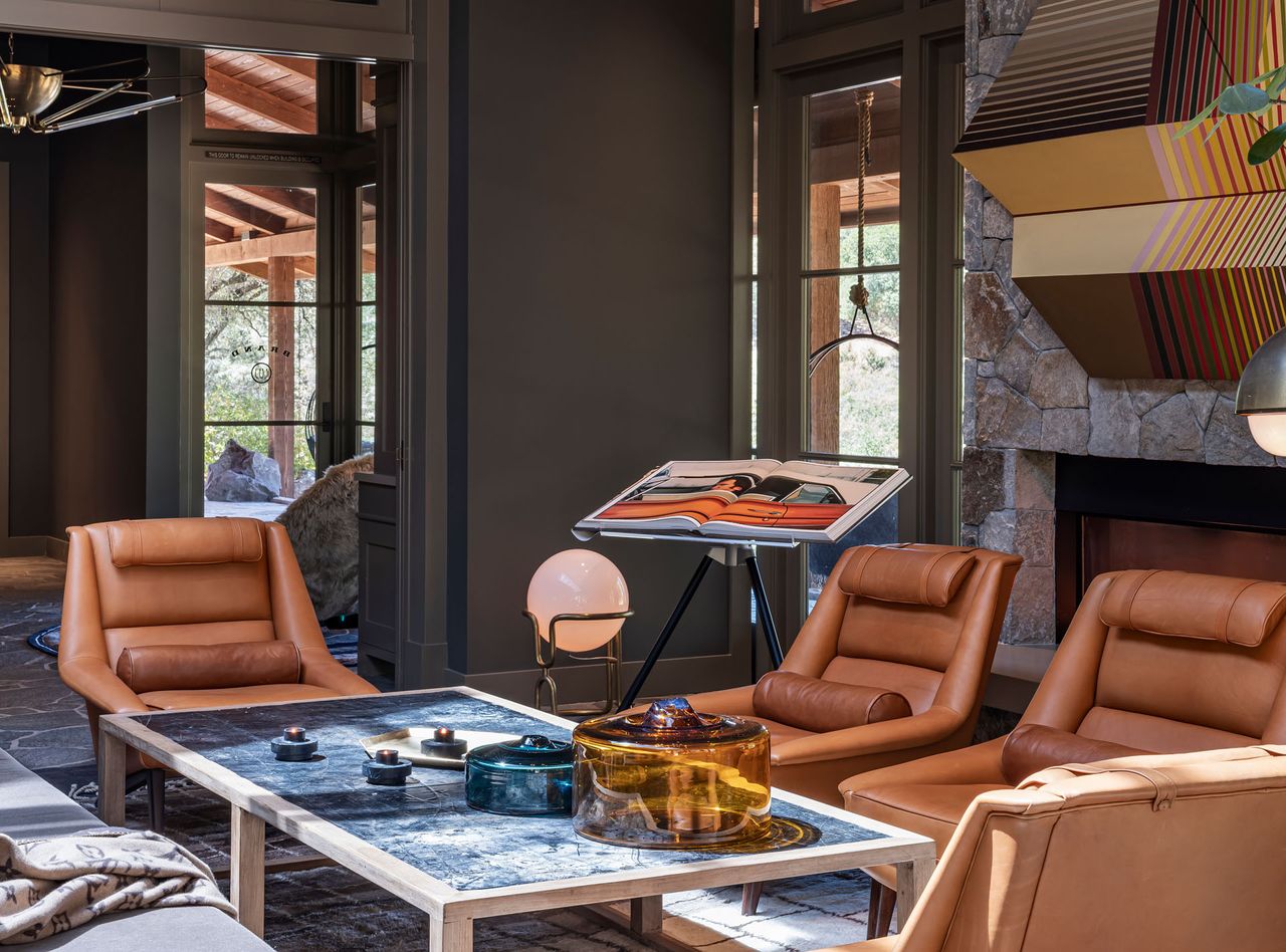 Brown leather chairs, blue stone top table with wooden frame