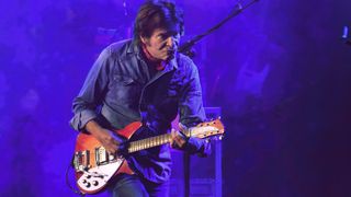 John Fogerty performs during the Rock Zottegem Festival on July 13, 2024 in Zottegem, Belgium. He's playing his Fireglo Rickenbacker 325 "ACME" from his days with Creedence Clearwater Revival. (The word ACME, in yellow paint, is just visible on the headstock where it would normally say Rickenbacker.) Note the addition of a humbucking pickup in the bridge position and the Bigsby whammy, two modifications he made after purchasing the guitar in 1968.