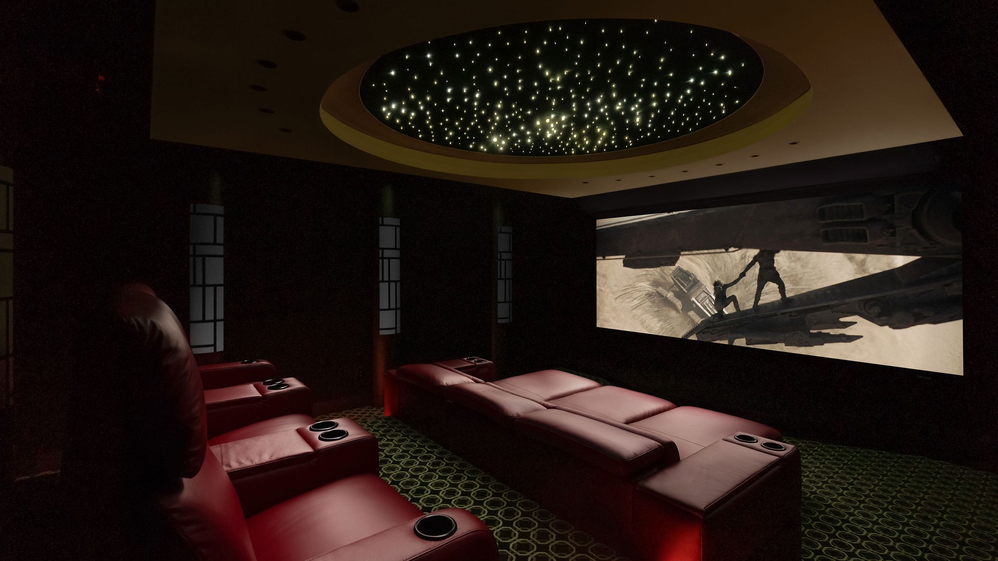 Home theater space with red seating and screen showing Dune 2