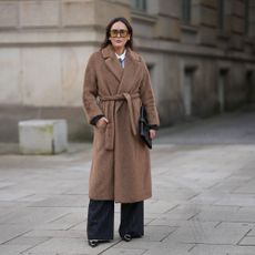 a woman wears a wrap coat