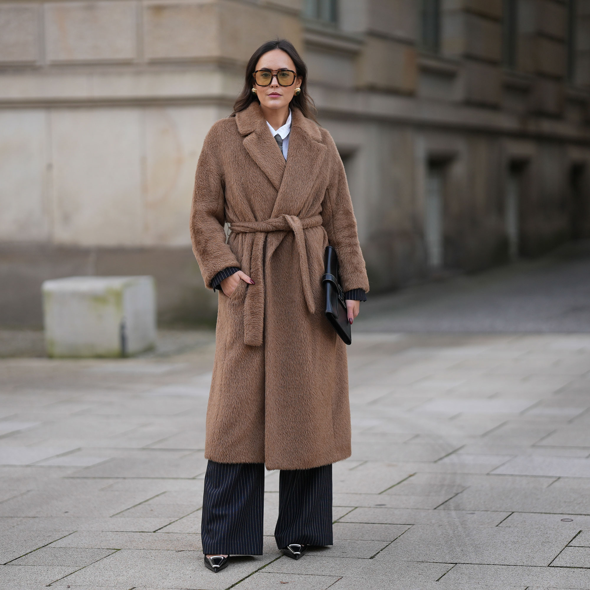 a woman wears a wrap coat