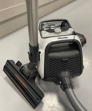 Miele Boost CX1 canister vacuum on concrete floor in Future test center