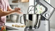Kenwood Chef XL Titanium Stand Mixer on a countertop with dough in the background