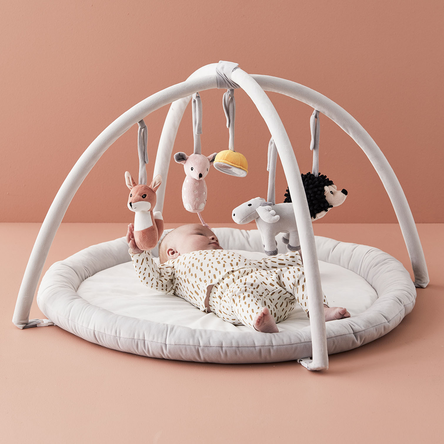 grey baby playgym with toy arches