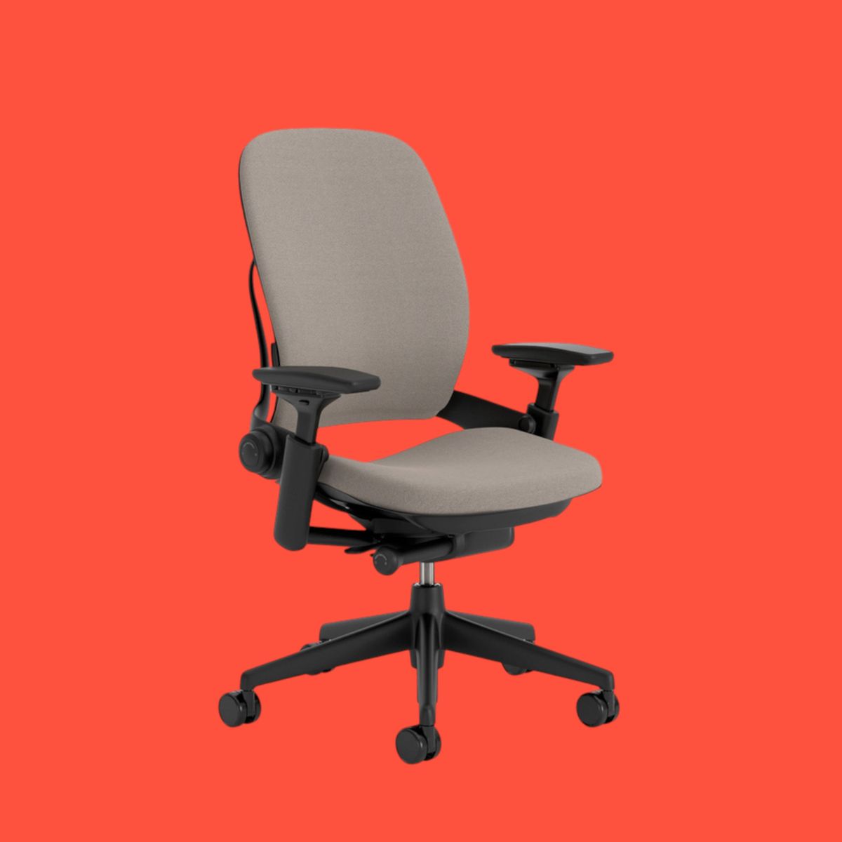 An image of a Steelcase Leap V2 office chair, against a bright red background.