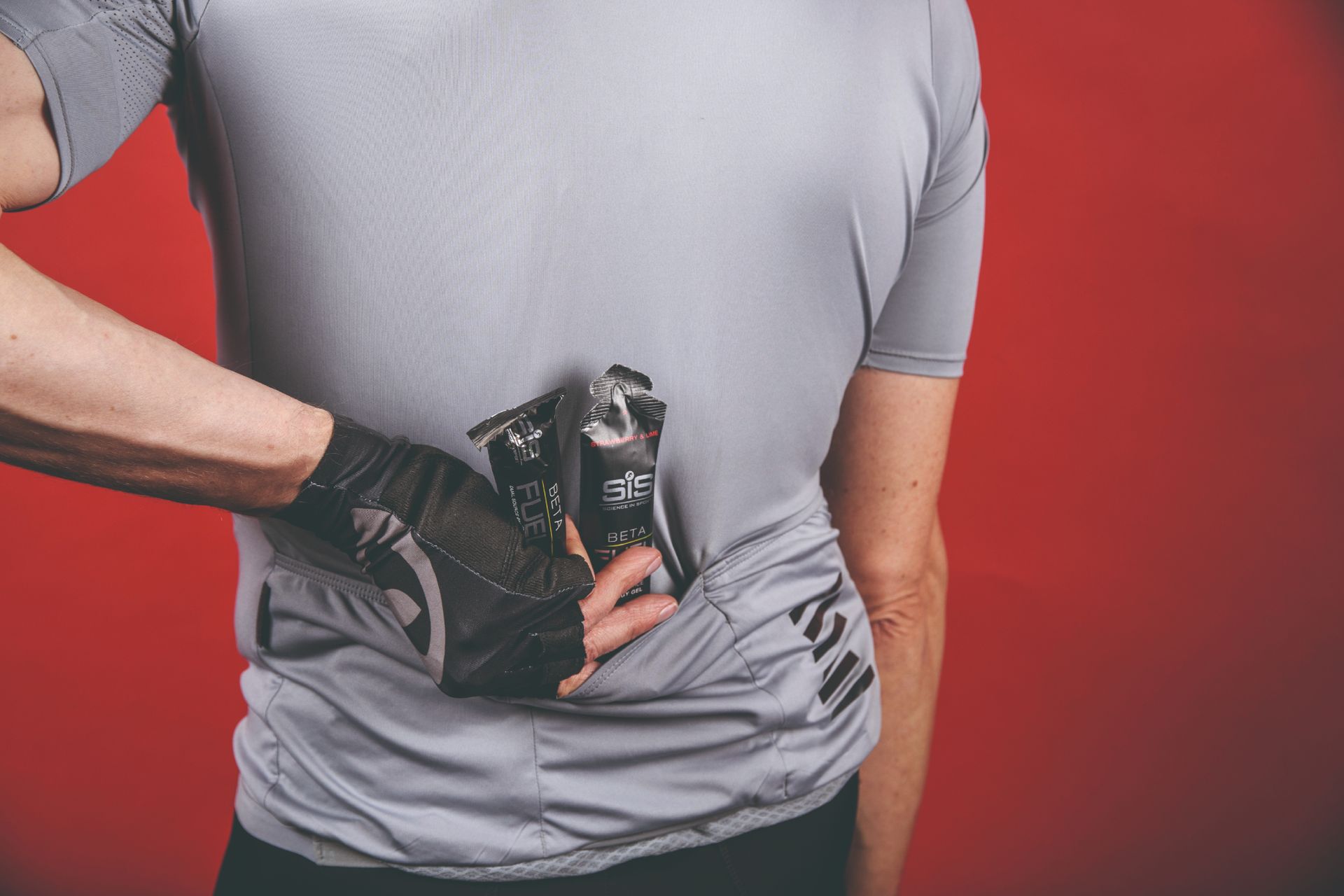 Image shows a cyclist consuming sugar on a bike ride