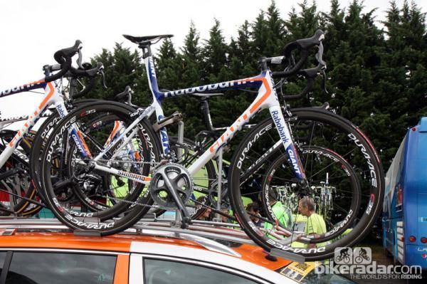 The brightly colored Giant TCR Advanced SL machines of team Rabobank, dressed in Shimano Dura-Ace groups and carbon-rimmed tubular wheels, PRO cockpits, and Vittoria tires.