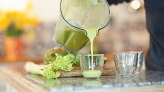 green celery juice being poured into glasses