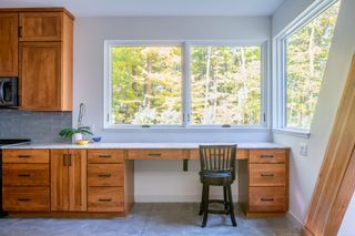 study looking out from horizontal window at Lake Placid A-Frame by Strand Design