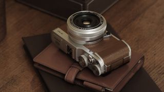 A Fujifilm X-M1 camera resting on a folio