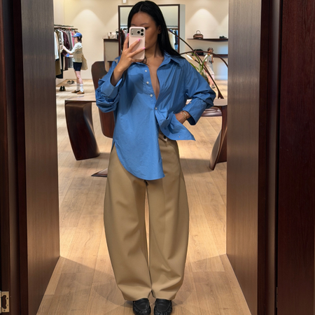 Influencer Caroline Lin wearing barrel leg trousers. 