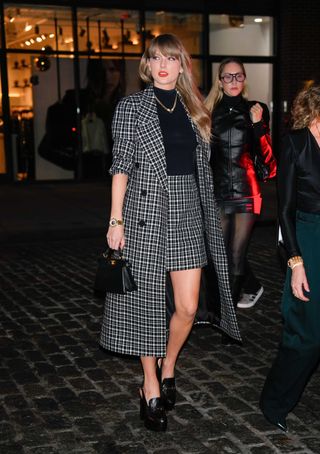 Taylor Swift wears a plaid Carolina Herrera set with Gucci loafers