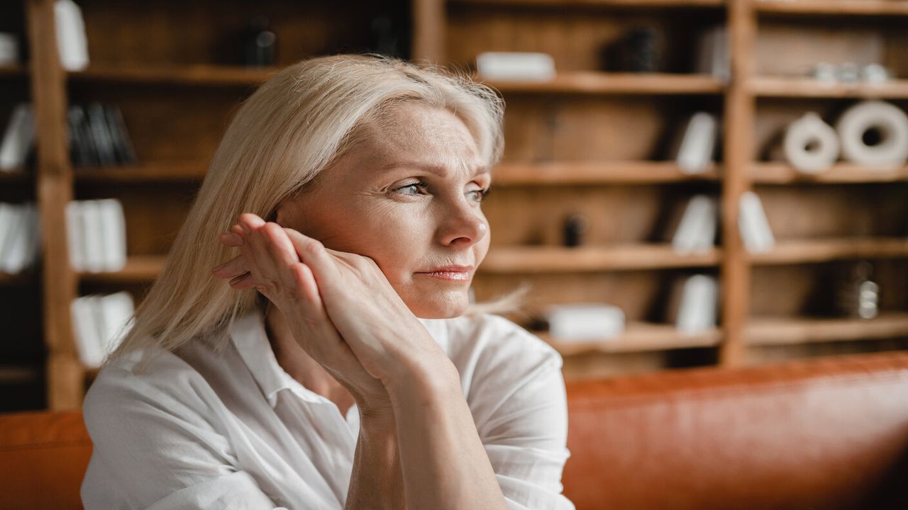 Older woman sat on a sofa